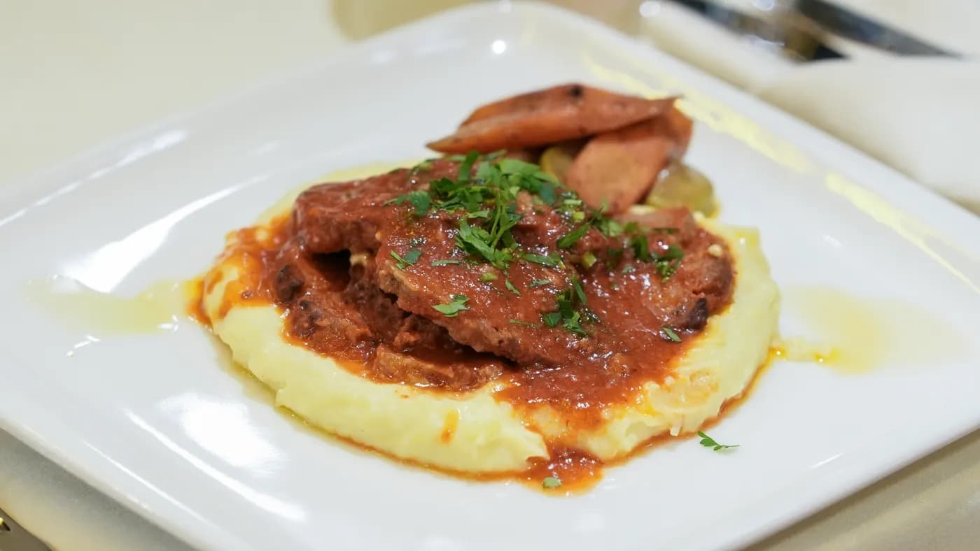 Grilled beef main course served with mashed potato and roasted vegetables